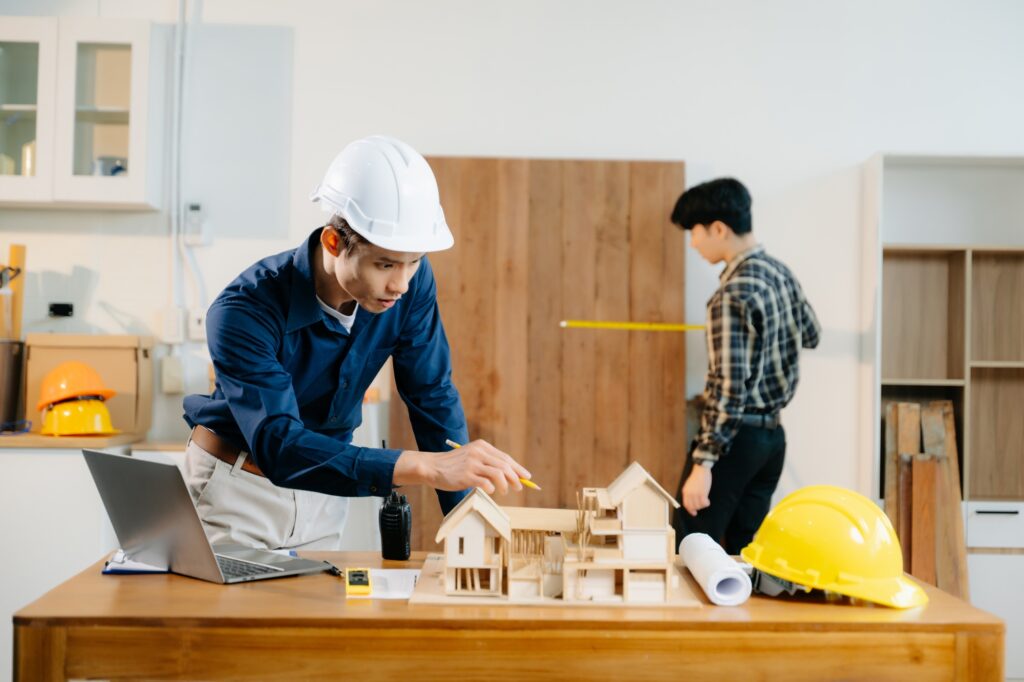 Architects and engineers collaborate on a building model, designing, planning, and measuring